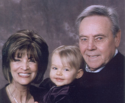 Photo of Christine Shatilla, husband and grandchild